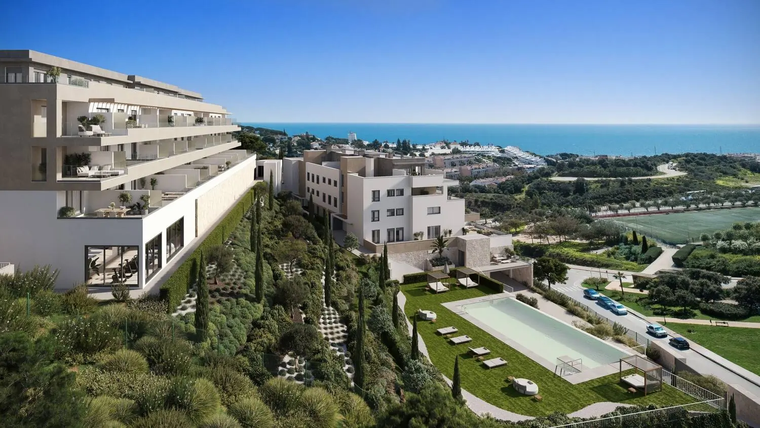 Complejo residencial moderno con piscina, jardines y vistas al mar desde una ladera